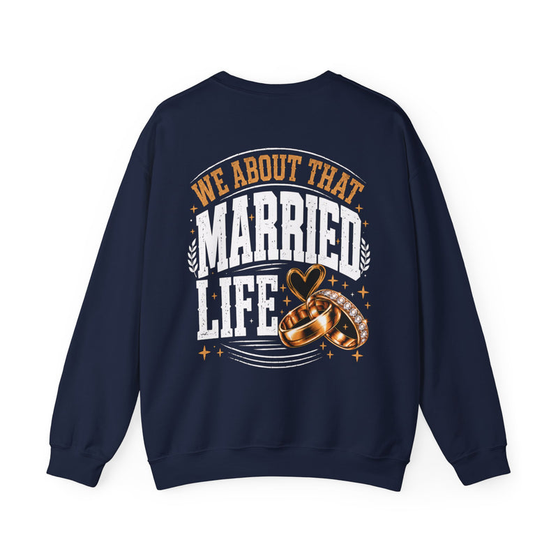 Navy sweatshirt with sand collegiate lettering reading WE ABOUT THAT MARRIED LIFE, flat-lay view.