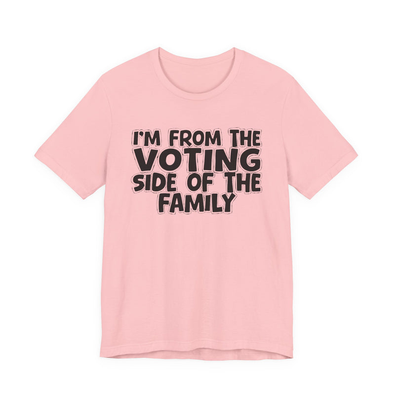 light t-shirt with ‘I’M FROM THE VOTING SIDE OF THE FAMILY’ statement text in bold outline lettering, front flat-lay view.