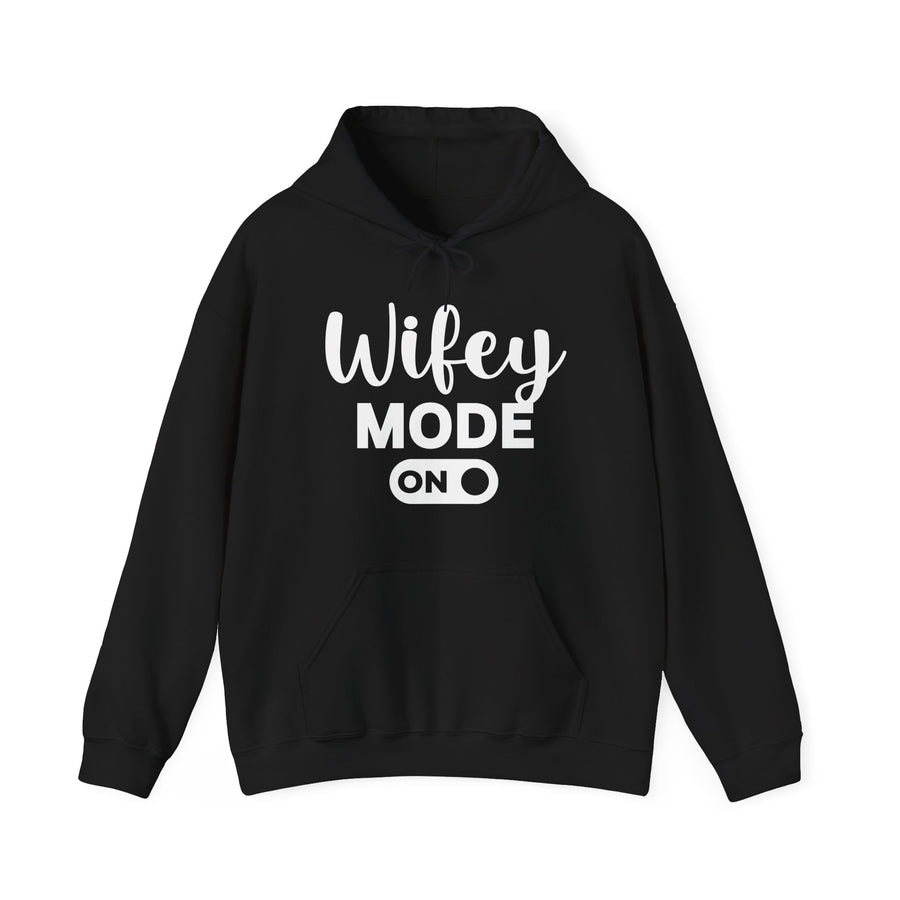 Black hoodie with grey bold block lettering reading WIFEY MODE ON, front flat-lay view.
