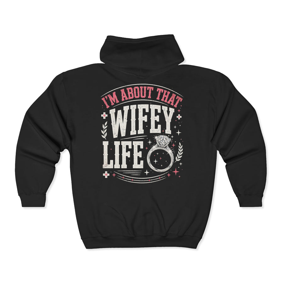 Black zip hoodie with white and pink western lettering reading "I'M ABOUT THAT WIFEY LIFE", back flat-lay view.