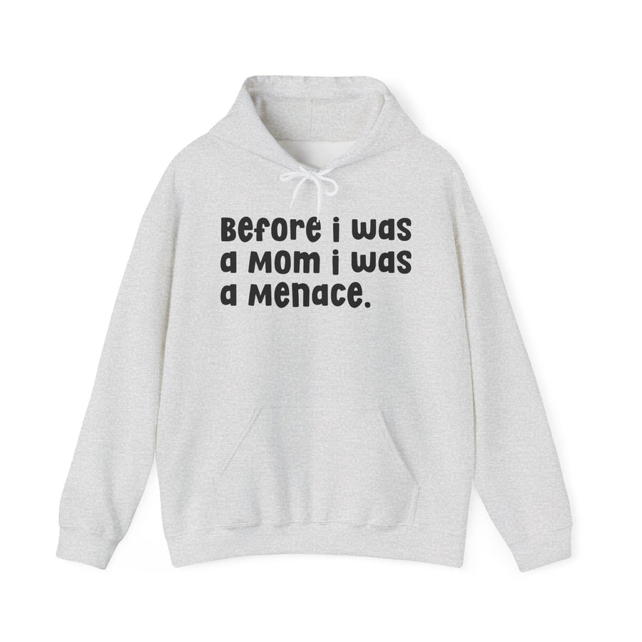 Ash hoodie with navy bold block lettering reading BEFORE I WAS A MOTHER I WAS A MENACE, front flat-lay view.