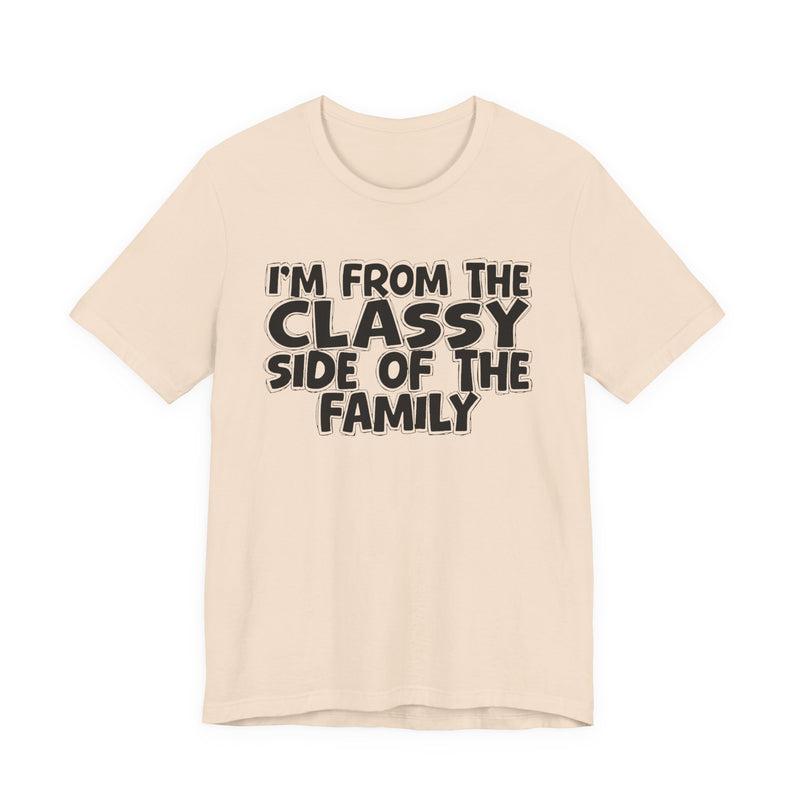 Natural t-shirt with 'I'M FROM THE CLASSY SIDE OF THE FAMILY' in black hand-drawn bubble lettering on the chest, front flat-lay mockup view.