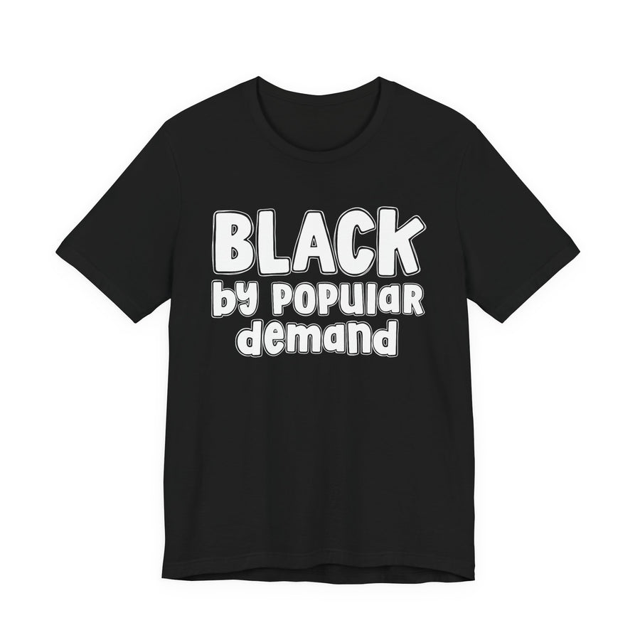 Black t-shirt with ‘BLACK by popular demand’ in bold block and script lettering graphic in light-contrast print, front flat-lay mockup view