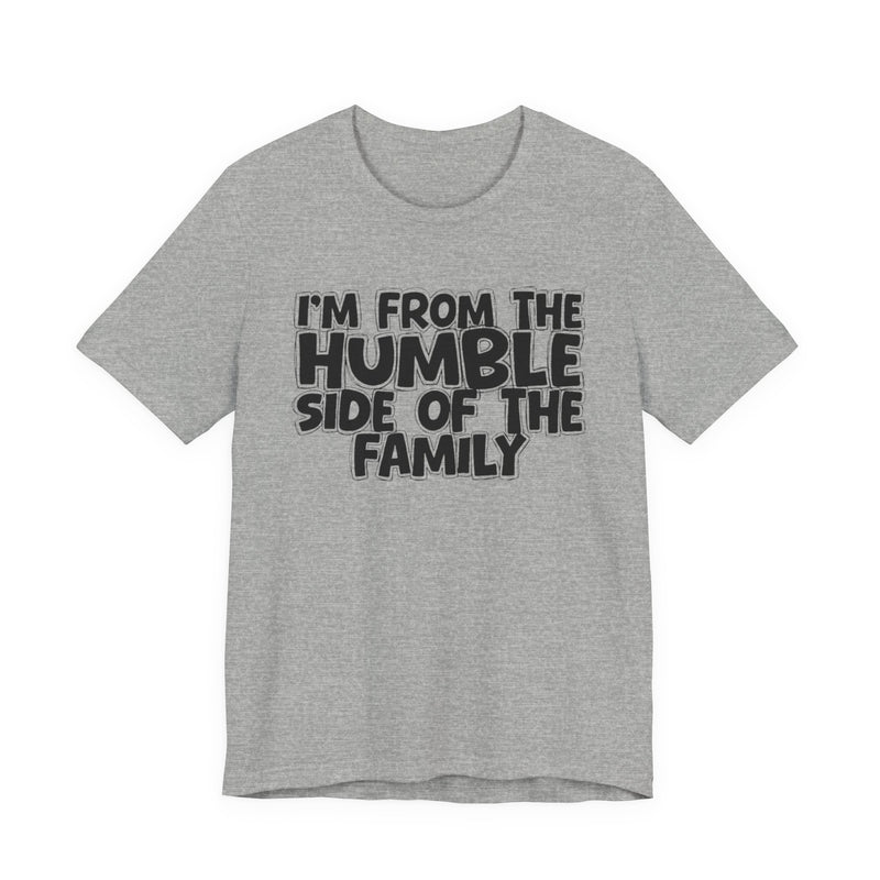 light t-shirt with ‘I’M FROM THE HUMBLE SIDE OF THE FAMILY’ statement text in bold outline lettering, front flat-lay view.
