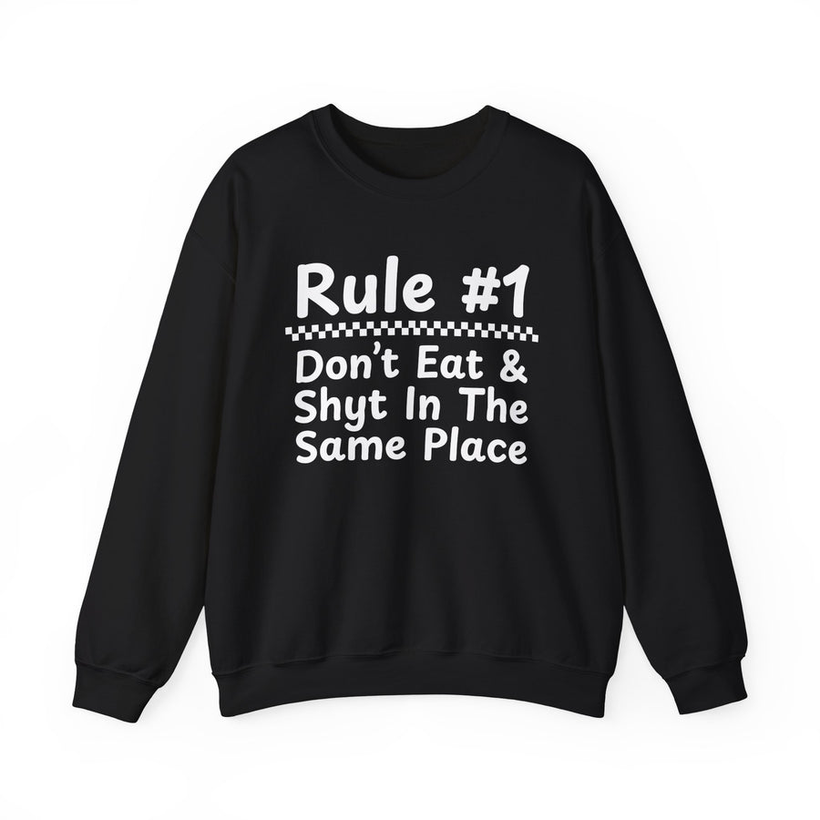 Rule #1 Don't Eat And Shyt In The Same Place — Sweatshirt front flat-lay: Rule #1 over a checkerboard divider over Don't Eat & / Shyt In The / Same Place in white rounded lettering on black. Street Talk Designs sarcastic statement apparel.