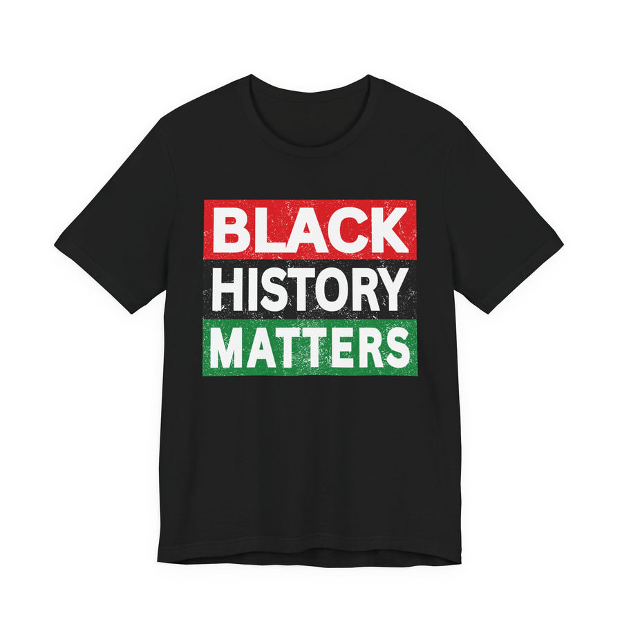 Black t-shirt with ‘BLACK HISTORY MATTERS’ in block letters on red, black and green bars graphic in light-contrast print, front flat-lay mockup view