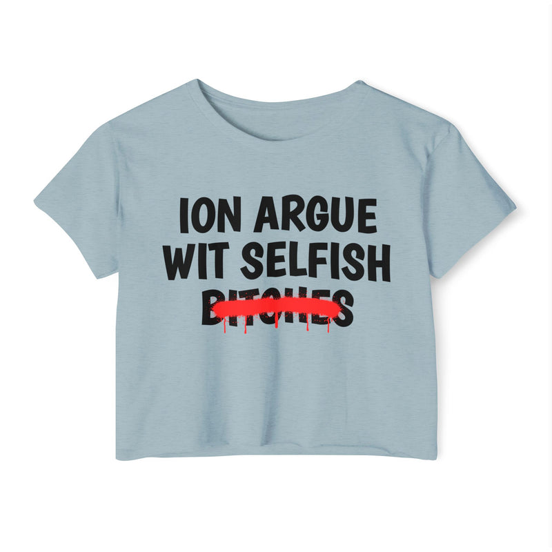 Antique Denim crop top with black "ION ARGUE WIT SELFISH BITCHES" chest print, red spray-paint strike-through across the last line, front flat-lay view.