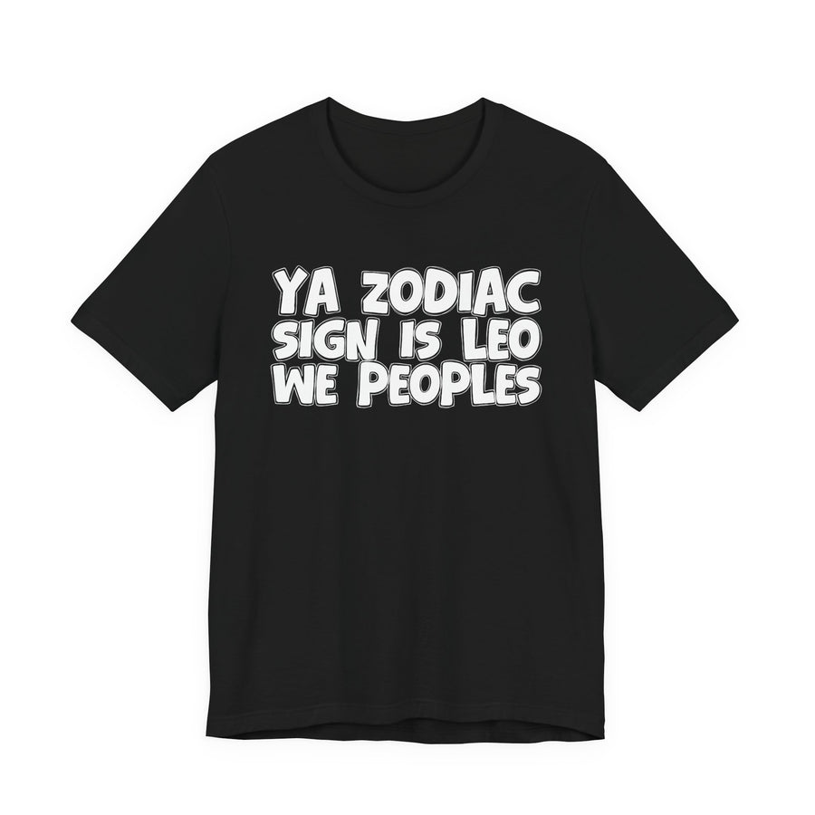 Black t-shirt with white 'YA ZODIAC SIGN IS LEO WE PEOPLES' rounded collegiate bubble lettering, front flat-lay view.