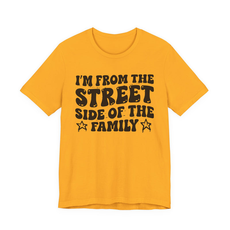 Gold t-shirt with white outlined bubble lettering reading 'I'M FROM THE STREET SIDE OF THE FAMILY', front flat-lay view.
