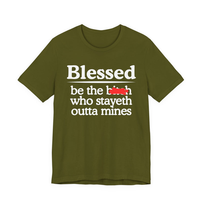 Olive tee with white serif lettering reading "Blessed be the b—h who stayeth outta mines", front flat-lay view, with a red redaction mark over the middle word.