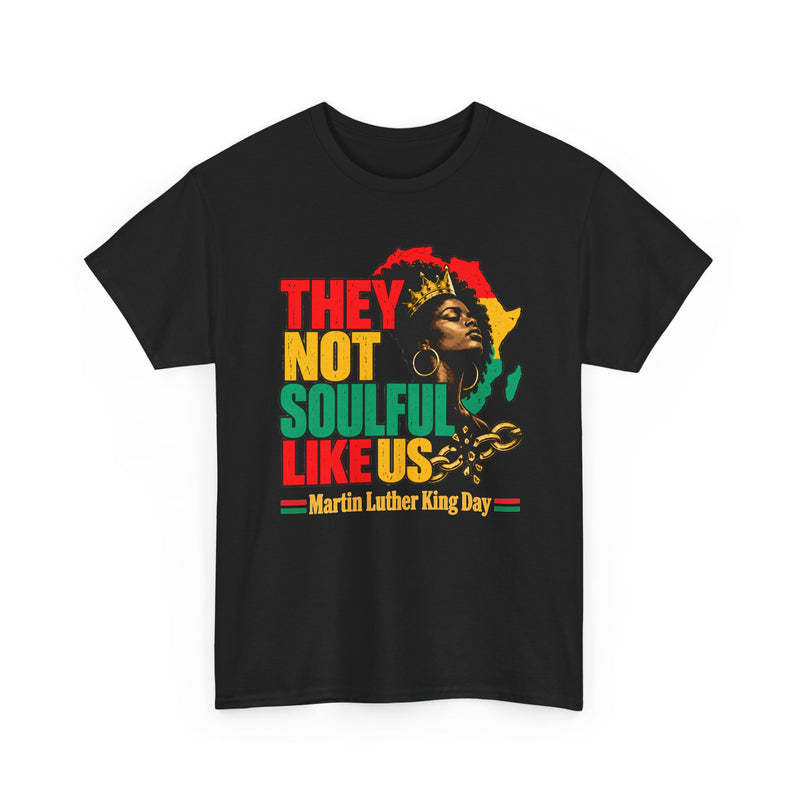 Black t-shirt with the They Not Soulful Like Us graphic: crowned queen against a Pan-African Africa map with a broken gold chain and a Martin Luther King Day banner, front view.