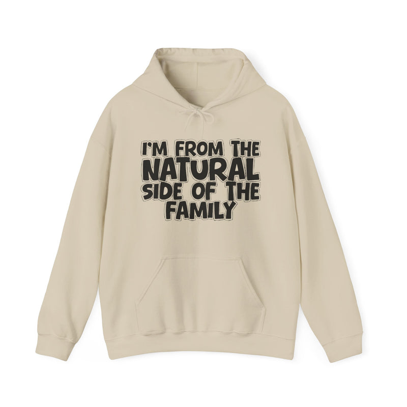 Sand hoodie with drawstring hood and kangaroo pocket with white outlined bubble lettering reading 'I'M FROM THE NATURAL SIDE OF THE FAMILY', front flat-lay view.