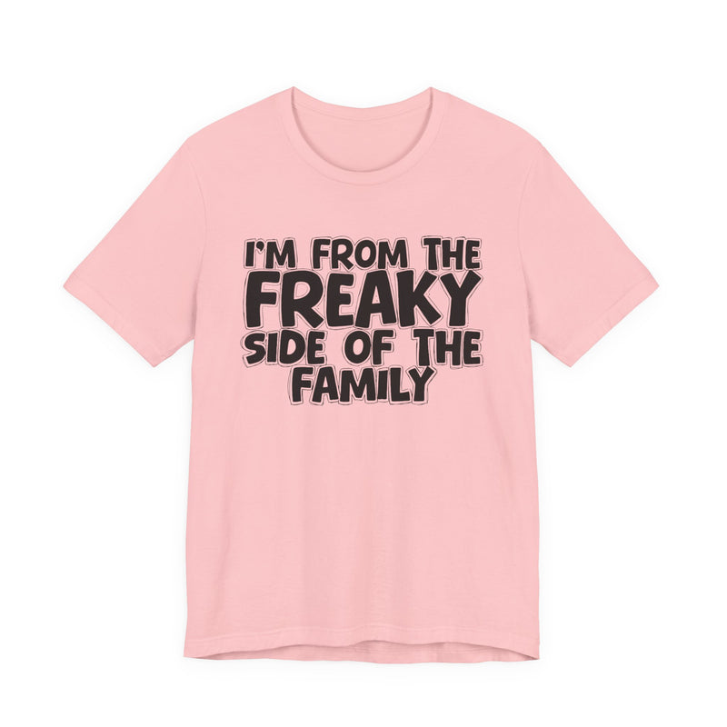 Charity Pink t-shirt with the "I'M FROM THE FREAKY SIDE OF THE FAMILY" statement design in white outlined block lettering, front flat-lay view.