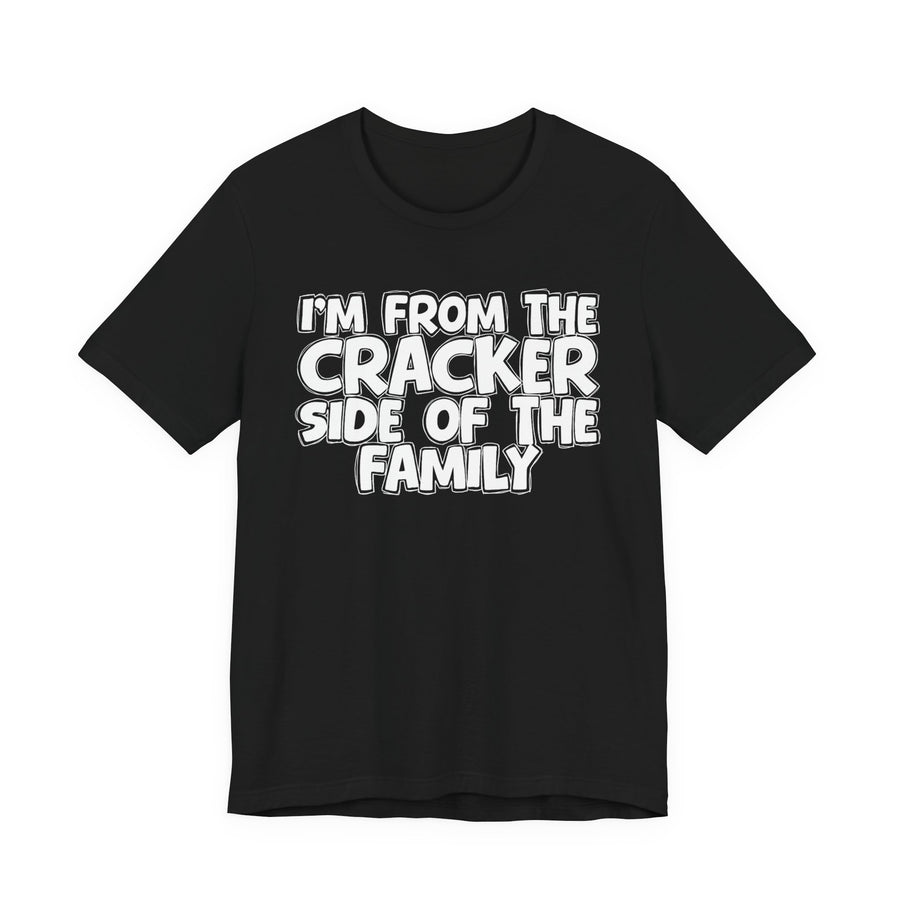 dark t-shirt with ‘I’M FROM THE CRACKER SIDE OF THE FAMILY’ statement text in bold outline lettering, front flat-lay view.