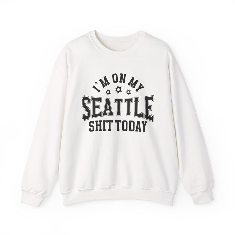 White sweatshirt with black varsity block lettering reading I'M ON MY SEATTLE SHIT TODAY, with bullet-hole accents, front flat-lay view.