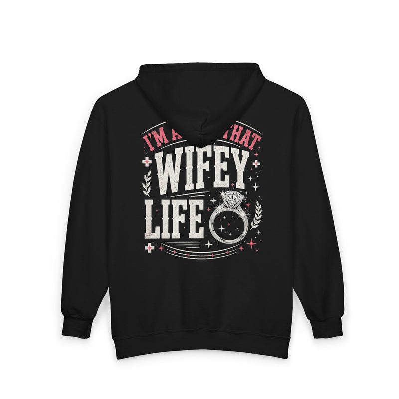 Black zip hoodie with white and pink western lettering reading "I'M ABOUT THAT WIFEY LIFE", back flat-lay view.