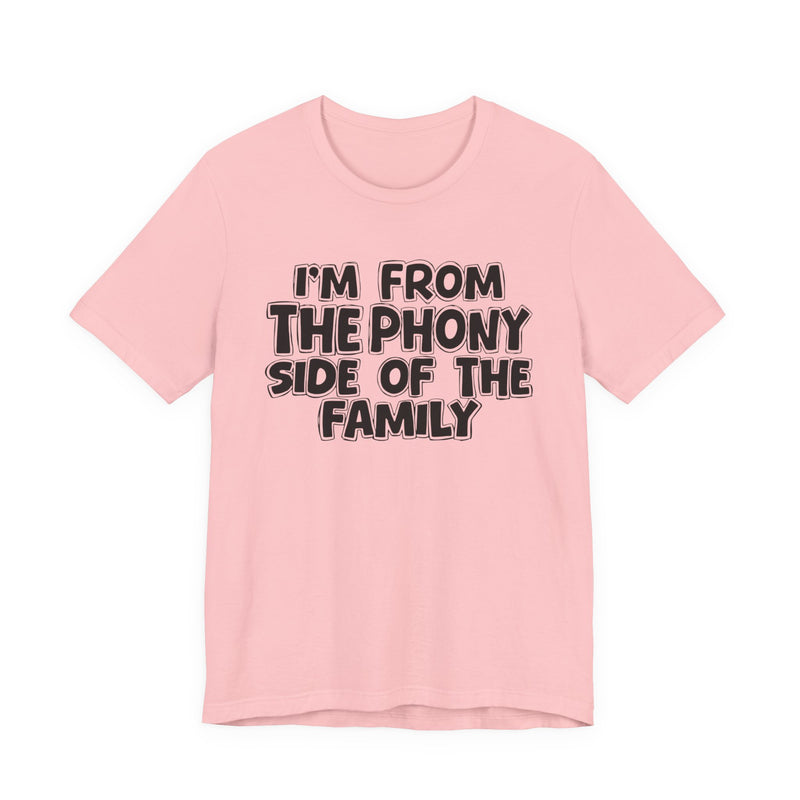 Pink t-shirt with white outlined bubble lettering reading 'I'M FROM THE THE SASSY SIDE OF THE FAMILY', front flat-lay view.