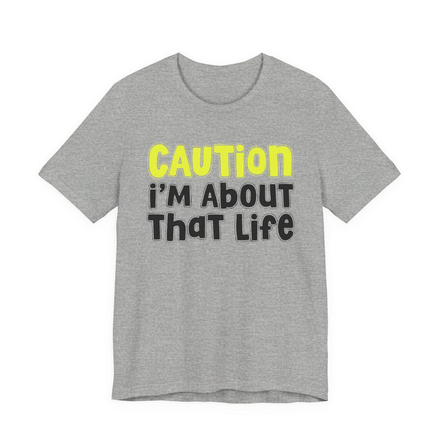 T-Shirt in Athletic Heather with lettering reading CAUTION I'M ABOUT THAT LIFE, front view