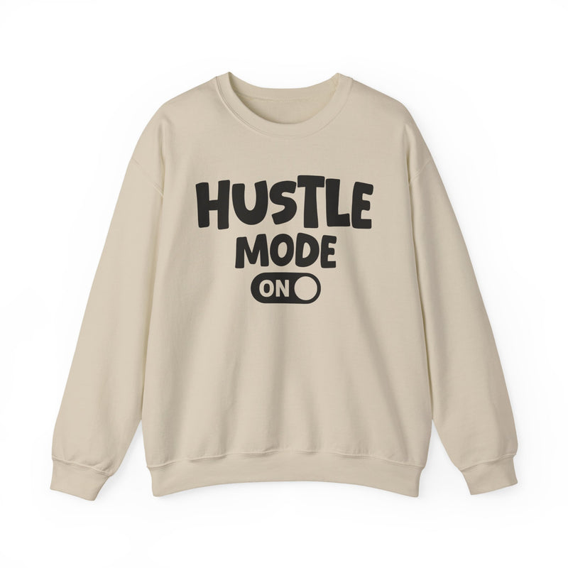 Sand sweatshirt with white bubble lettering reading "HUSTLE MODE ON", front flat-lay view.
