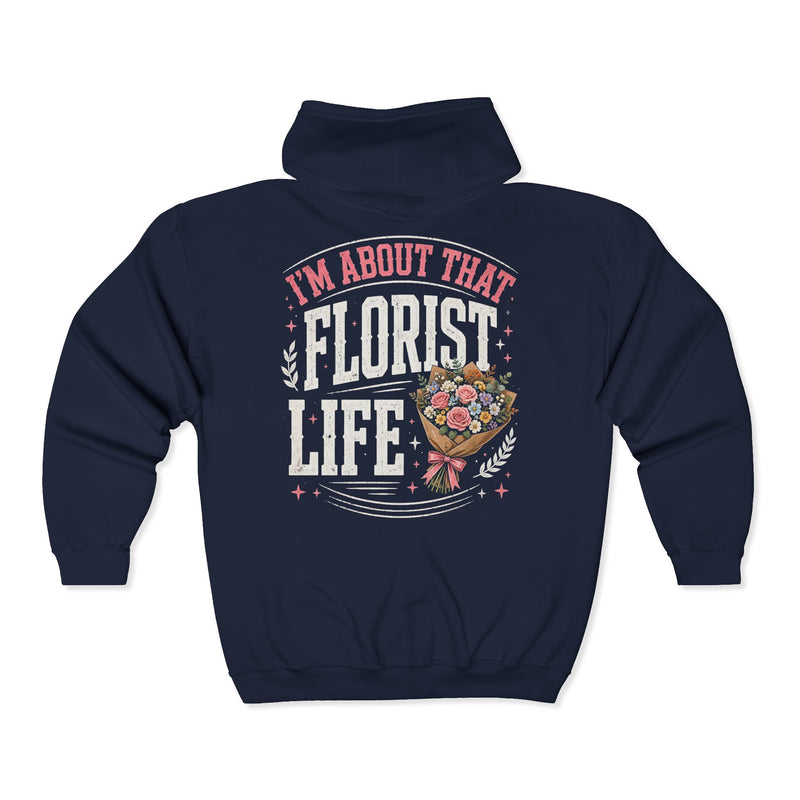 Navy zip hoodie with white and pink lettering reading "I'M ABOUT THAT FLORIST LIFE", back view.