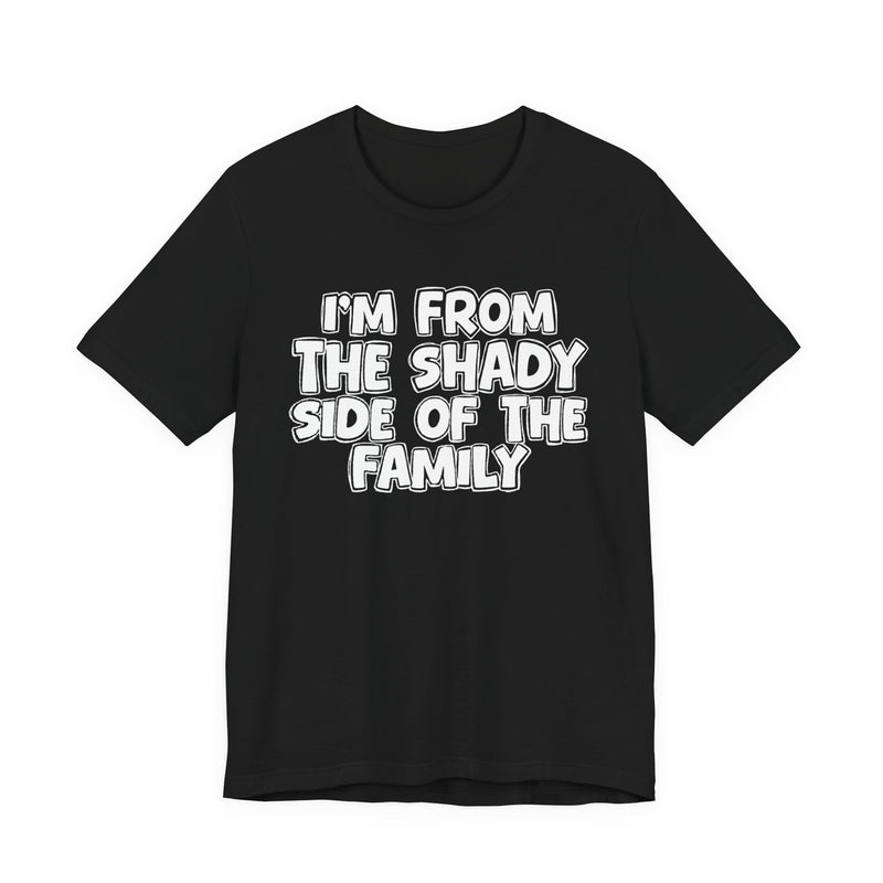 dark t-shirt with ‘I’M FROM THE SHADY SIDE OF THE FAMILY’ statement text in bold outline lettering, front flat-lay view.