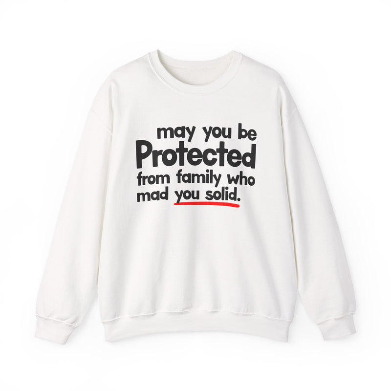 May You Be Protected From Family Who Mad You Solid — Sweatshirt fabric detail close-up: MAY YOU BE PROTECTED FROM FAMILY WHO MAD YOU SOLID in bold statement lettering. Street Talk Designs protection statement apparel.