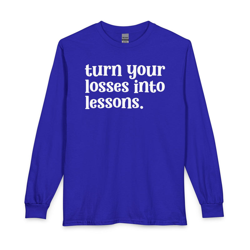 Royal blue long sleeve t-shirt with white "turn your losses into lessons." lettering, front view.