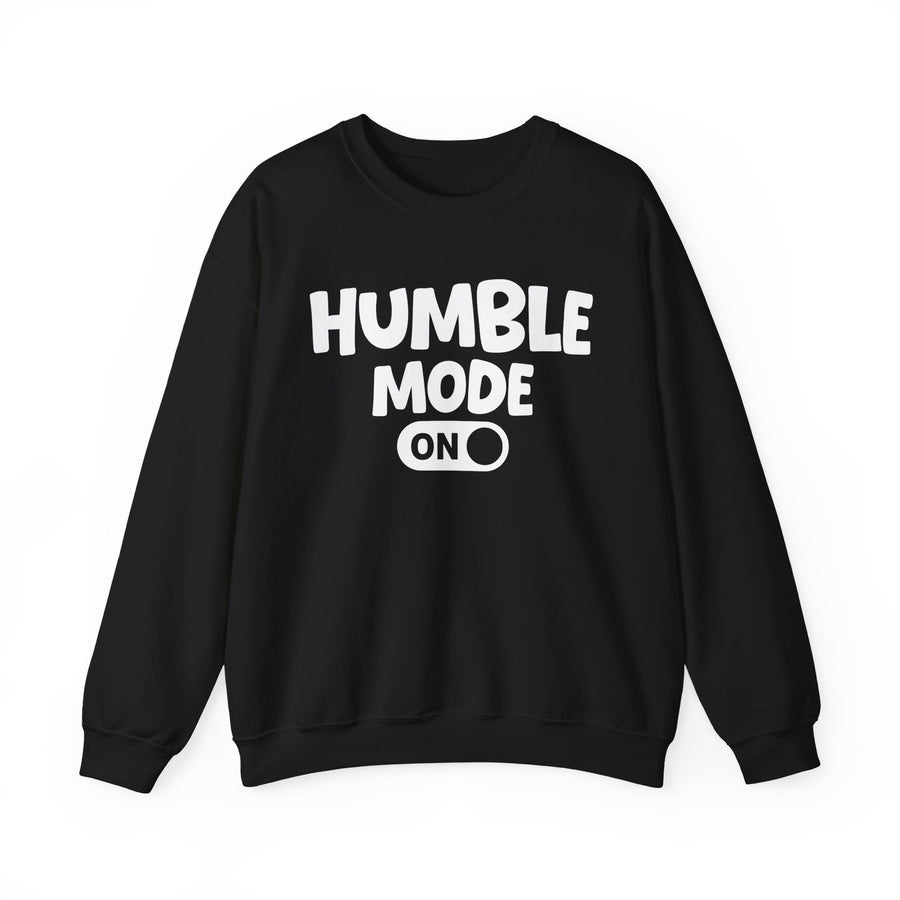 Black sweatshirt with white bubble lettering reading "HUMBLE MODE ON", front flat-lay view.