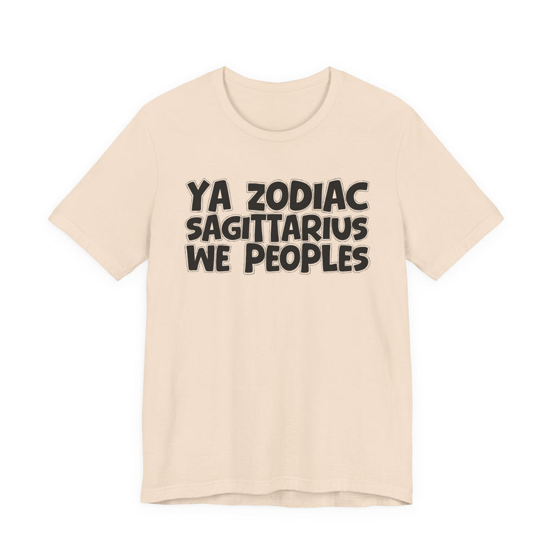 Tan t-shirt with black hand-lettered YA ZODIAC SAGITTARIUS WE PEOPLES print, front flat-lay view.