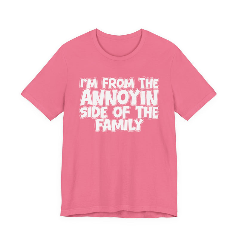 light t-shirt with ‘I’M FROM THE ANNOYIN SIDE OF THE FAMILY’ statement text in bold outline lettering, front flat-lay view.