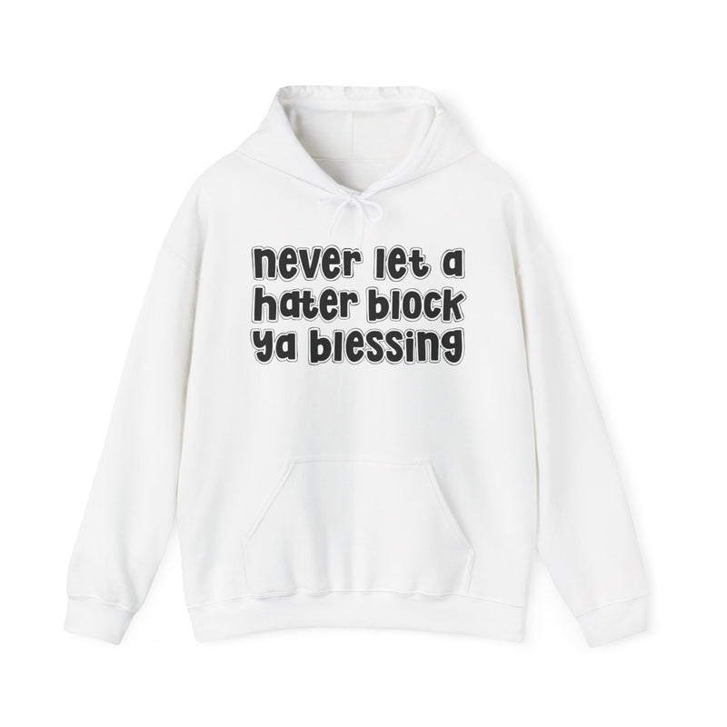 White hoodie with black outlined bubble lettering reading "never let a hater block ya blessing", front flat-lay view.