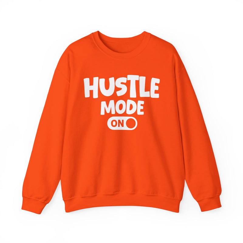 Orange sweatshirt with white bubble lettering reading "HUSTLE MODE ON", front flat-lay view.