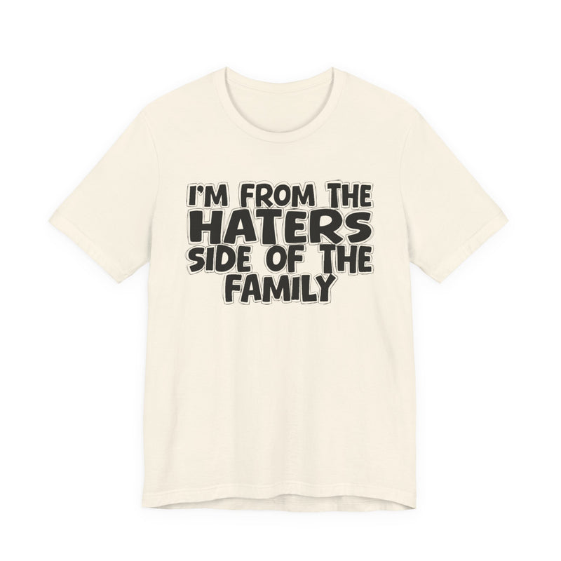 Charity Pink t-shirt with bold chest statement text reading 'I'M FROM THE HATERS SIDE OF THE FAMILY,' front flat-lay view.