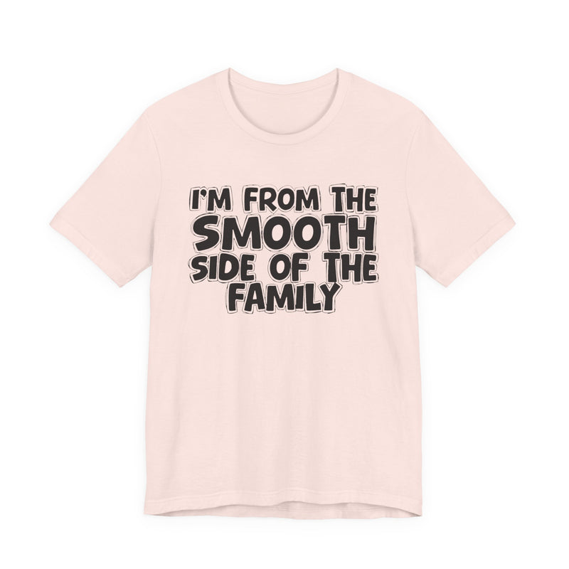 Soft Pink t-shirt, printed with the "I'M FROM THE SMOOTH SIDE OF THE FAMILY" statement in bold outlined bubble lettering, front flat-lay view.