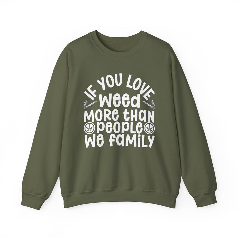 If You Love Weed More Than People We Family — Sweatshirt front view: IF YOU LOVE WEED MORE THAN PEOPLE WE FAMILY in white playful lettering with joint and leaf graphics — white playful lettering with joint and leaf graphics on olive. Street Talk Designs 420-friendly statement apparel.