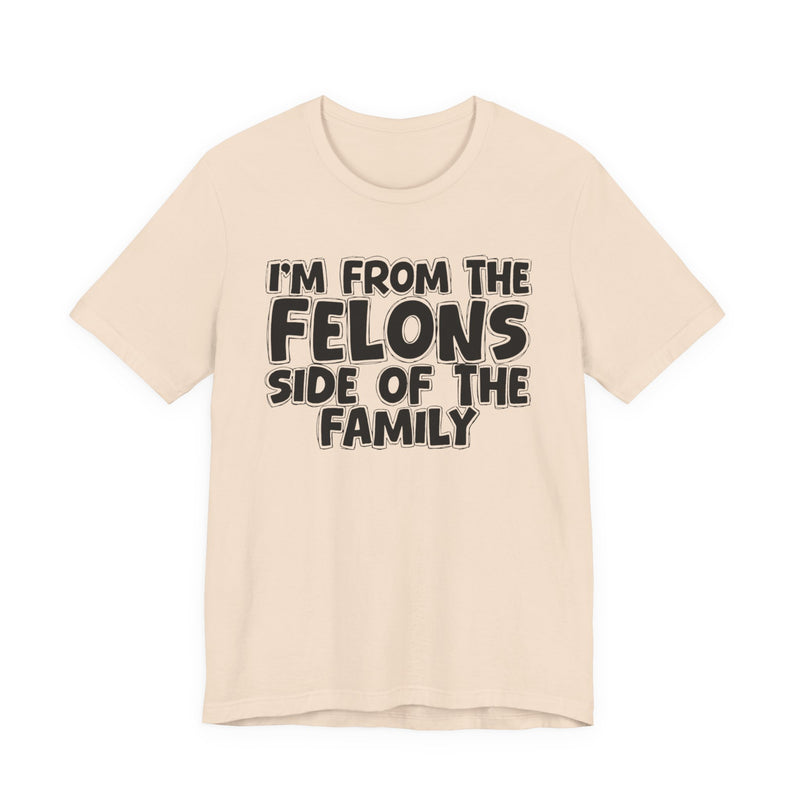 Soft Cream t-shirt with white outlined bubble lettering reading 'I'M FROM THE FELONS SIDE OF THE FAMILY', front flat-lay view.