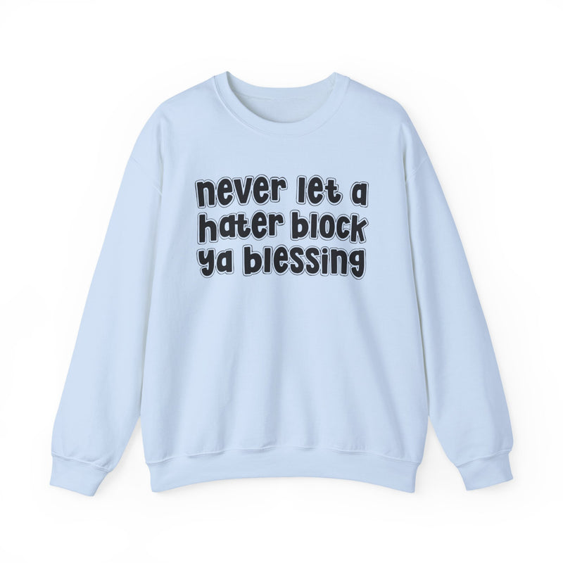 Light Blue sweatshirt with black outlined bubble lettering reading "never let a hater block ya blessing", front flat-lay view.