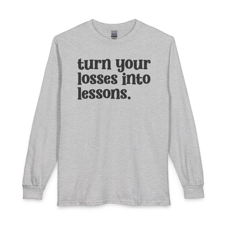 Sport grey long sleeve t-shirt with black "turn your losses into lessons." lettering, front view.