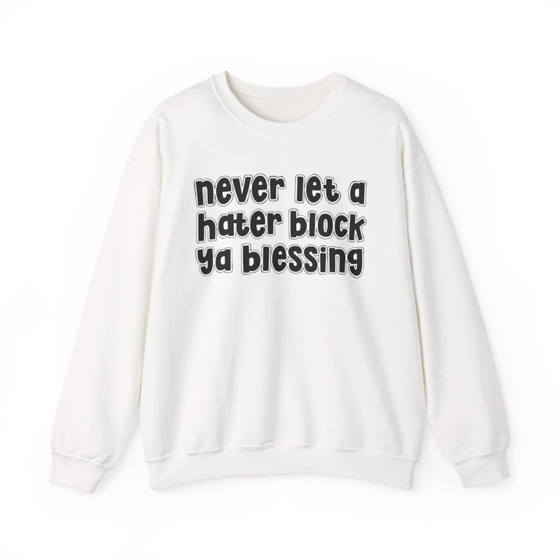 White sweatshirt with black outlined bubble lettering reading "never let a hater block ya blessing", front flat-lay view.
