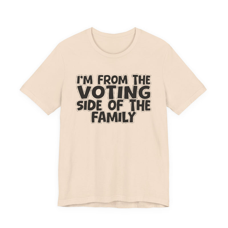 light t-shirt with ‘I’M FROM THE VOTING SIDE OF THE FAMILY’ statement text in bold outline lettering, front flat-lay view.