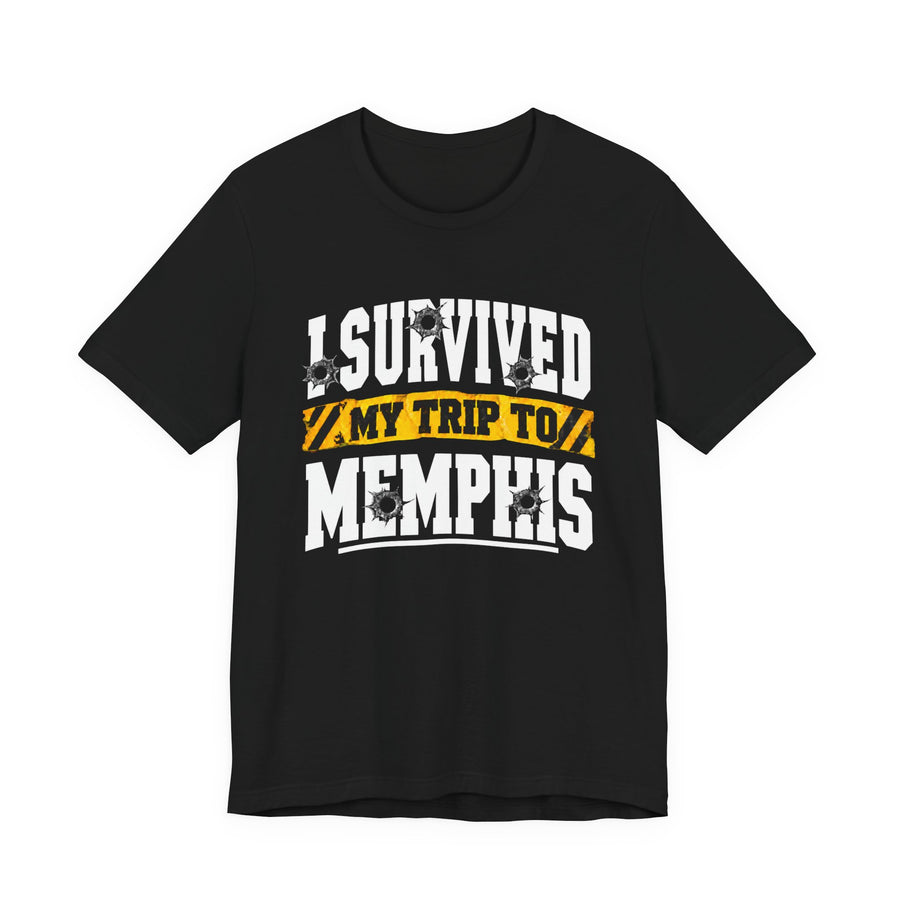T-Shirt product photo with arched collegiate lettering reading "I SURVIVED" with bullet-hole decals, a caution-tape band reading "MY TRIP TO", and large block letters reading "MEMPHIS", front view.