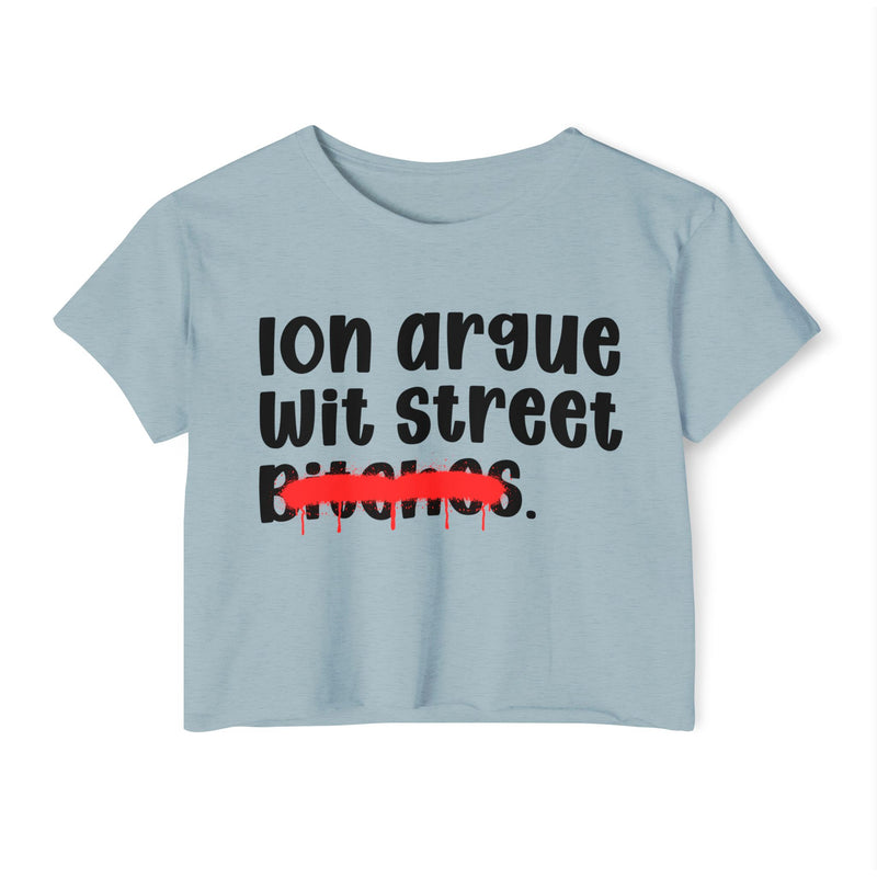 Dusty light blue crop top with black printed statement graphic, front view: "Ion argue" and "Wit street" in rounded chunky lettering over distressed "Bitches." crossed by a red spray-paint strike with paint drips
