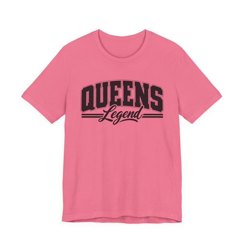 Hot pink t-shirt with black varsity block and script lettering reading QUEENS LEGEND, front flat-lay view.