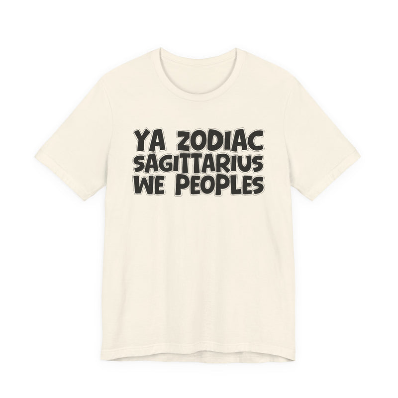 Cream t-shirt with black hand-lettered YA ZODIAC SAGITTARIUS WE PEOPLES print, front flat-lay view.