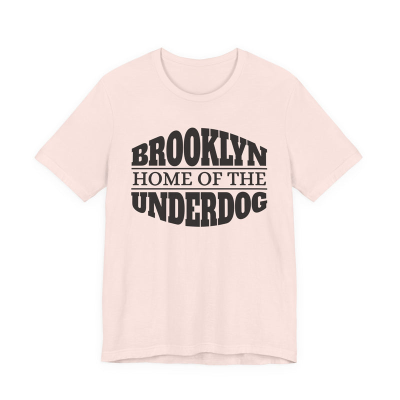T-shirt with bold lettering reading BROOKLYN (HOME OF THE) UNDERDOG, product view.
