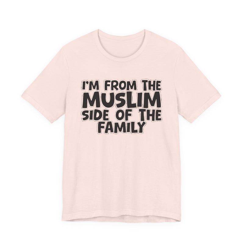 Soft Pink t-shirt, printed with the "I'M FROM THE MUSLIM SIDE OF THE FAMILY" statement in bold outlined bubble lettering, front flat-lay view.