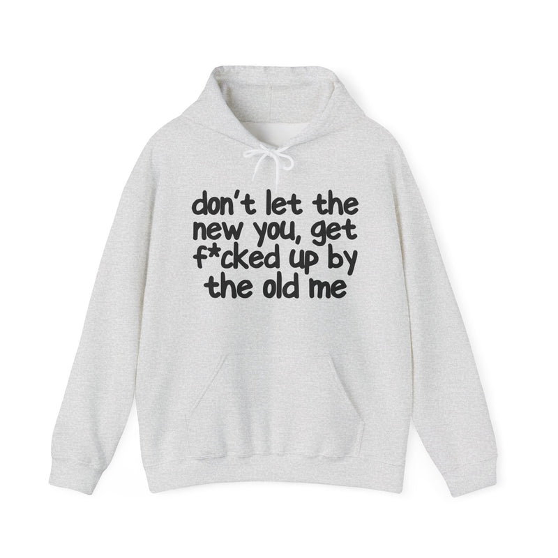 Ash hoodie with dark bold confrontation lettering reading DON'T LET THE NEW YOU, GET FUCK'D UP BY THE OLD ME, front flat-lay view.