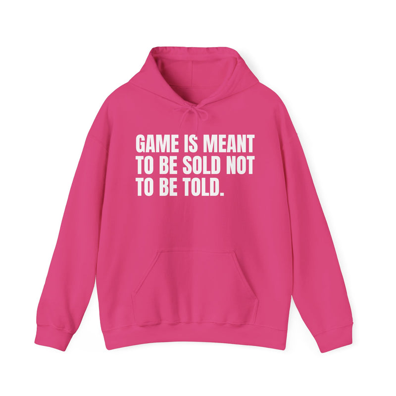Heliconia hoodie with white condensed block lettering reading "GAME IS MEANT TO BE SOLD NOT TO BE TOLD.", front flat-lay view.