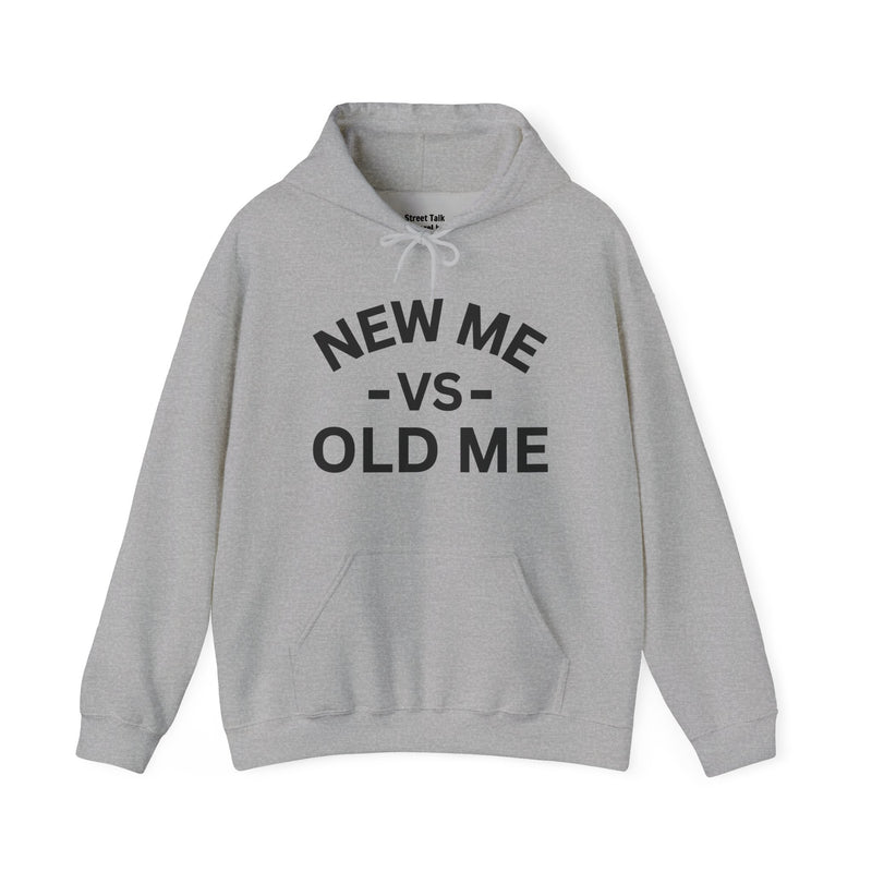 Sport grey hoodie with black bold statement lettering reading NEW ME VS OLD ME, front flat-lay view.