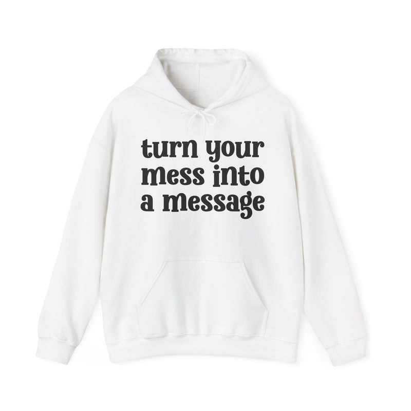 Heather gray hoodie with white lettering reading "turn your mess into a message", front flat-lay view.